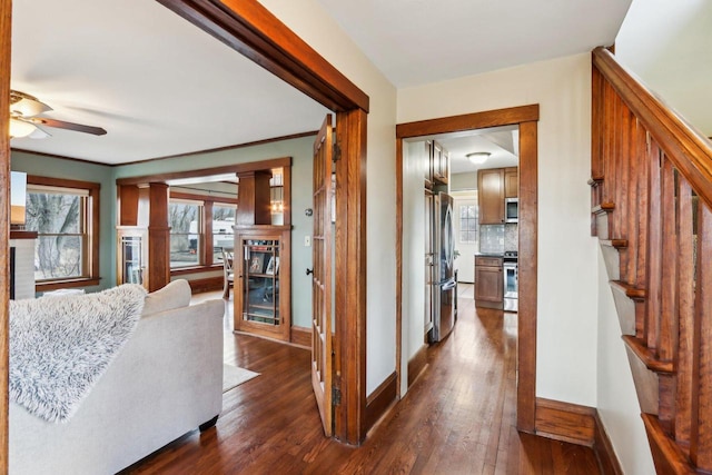 hall featuring dark wood-style floors, stairway, and baseboards