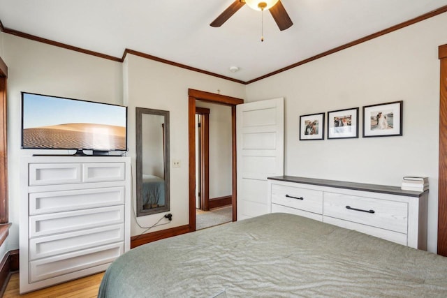 bedroom featuring ornamental molding, baseboards, and a ceiling fan