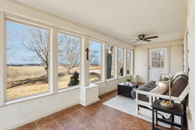 sunroom featuring ceiling fan