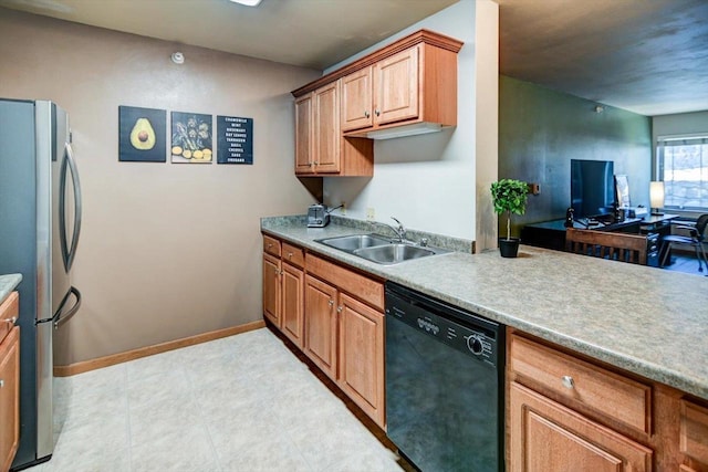 kitchen featuring a sink, baseboards, light countertops, freestanding refrigerator, and dishwasher