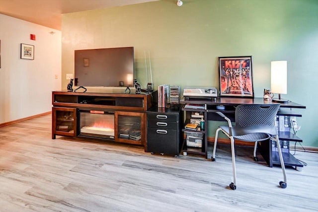 office area featuring light wood finished floors and baseboards