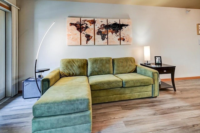 living room with baseboards and wood finished floors