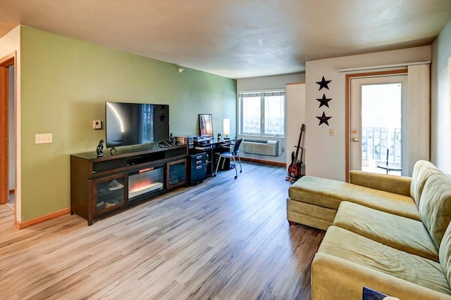 living area with baseboards and wood finished floors