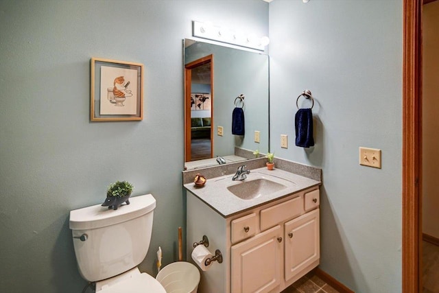 half bath featuring toilet and vanity