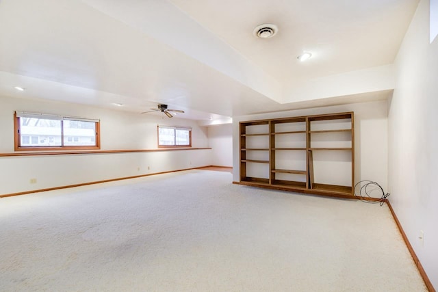 spare room with visible vents, carpet flooring, a ceiling fan, and baseboards