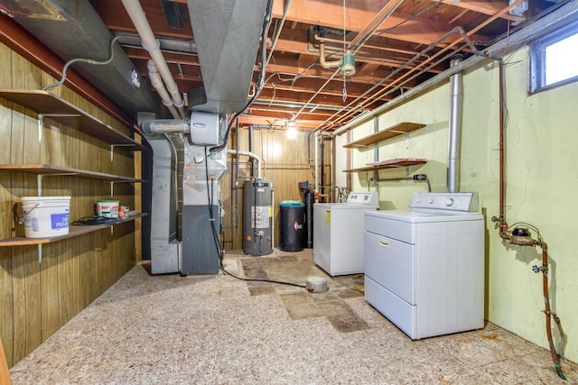 below grade area with water heater, washing machine and clothes dryer, and heating unit