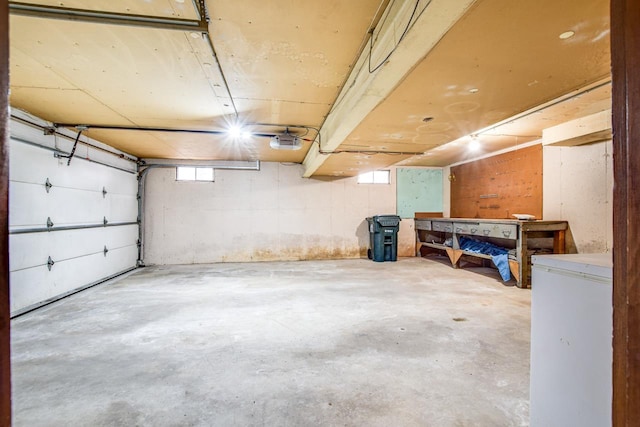 garage with white fridge and a garage door opener