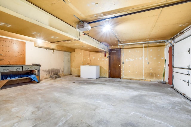 garage with fridge and a garage door opener