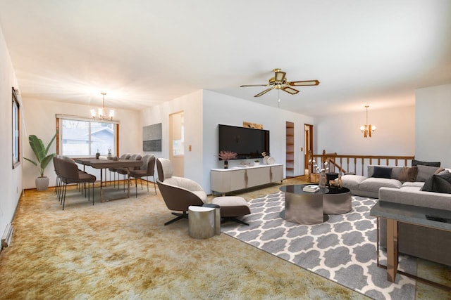 living room featuring carpet flooring and ceiling fan with notable chandelier