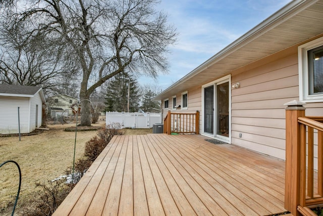 wooden terrace featuring fence and a lawn