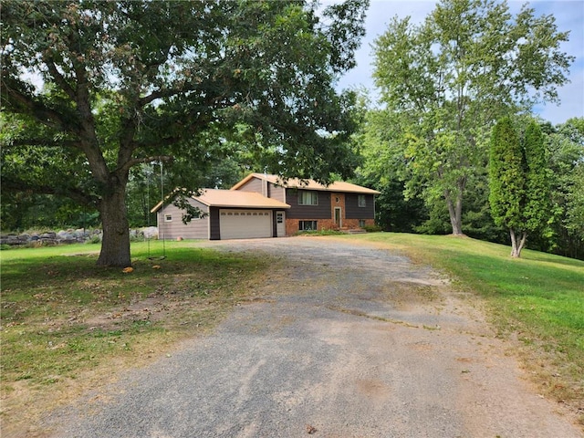 view of front of home with a garage, driveway, and a front yard