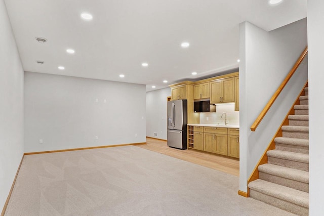 kitchen with decorative backsplash, recessed lighting, baseboards, and stainless steel fridge with ice dispenser