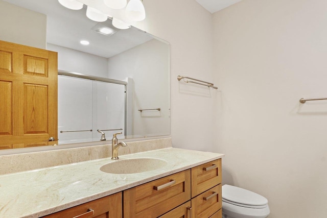 full bath with vanity, toilet, and an enclosed shower