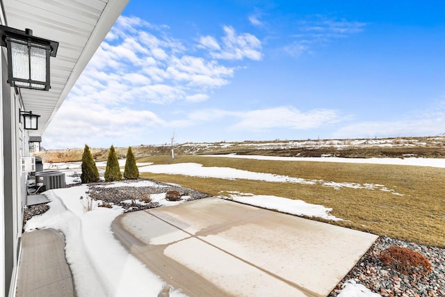 snowy yard with central AC unit