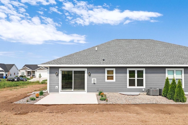 rear view of property with a patio, a shingled roof, and cooling unit