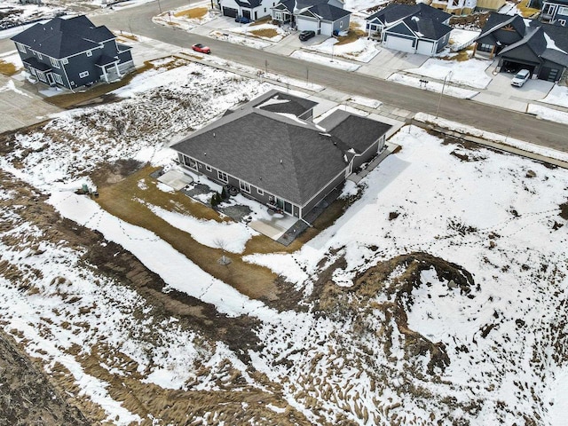 snowy aerial view with a residential view