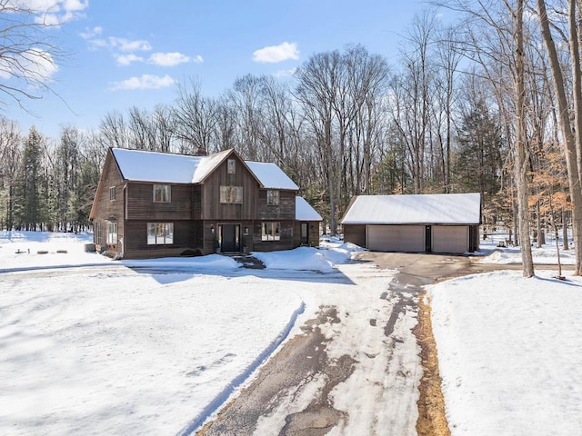 view of front of property with a garage and an outbuilding