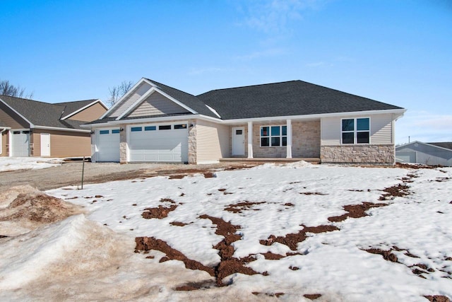 single story home featuring a garage and stone siding