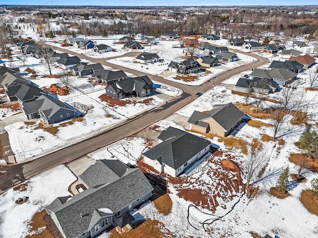 snowy aerial view with a residential view