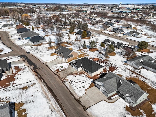 snowy aerial view with a residential view