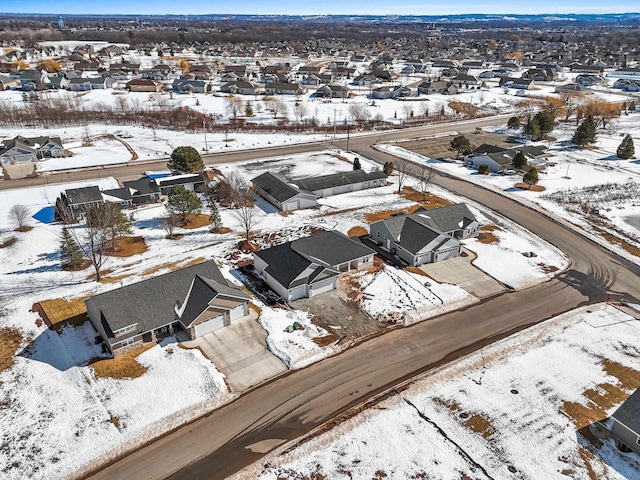 snowy aerial view with a residential view