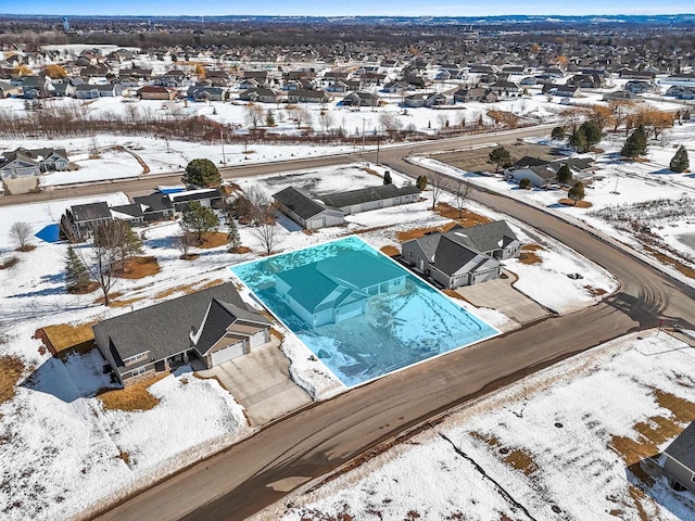 snowy aerial view featuring a residential view