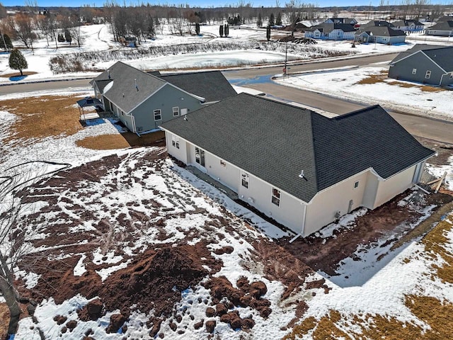 snowy aerial view with a residential view