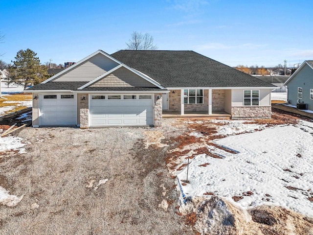 view of front of home with stone siding and driveway