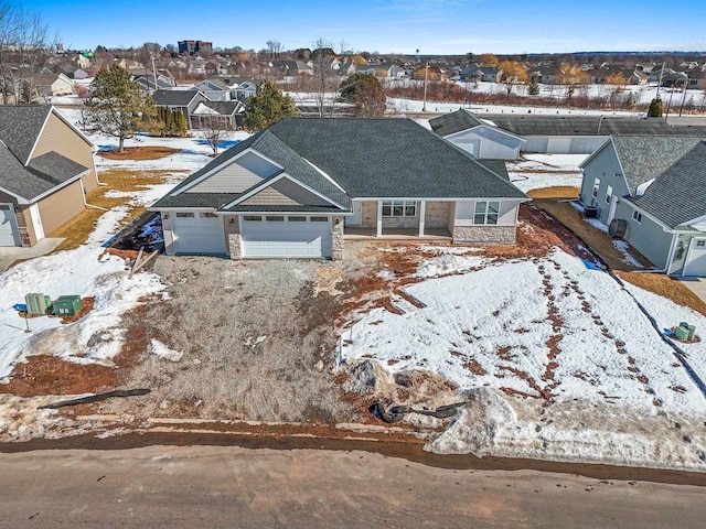 snowy aerial view with a residential view