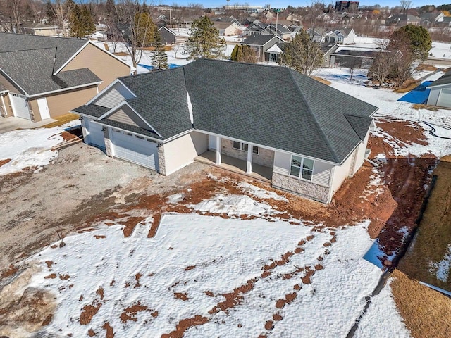 snowy aerial view featuring a residential view