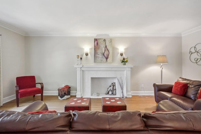 living room with crown molding, a fireplace, baseboards, and wood finished floors