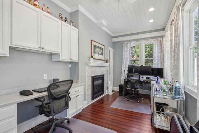 office area featuring dark wood finished floors, a tiled fireplace, wooden ceiling, crown molding, and recessed lighting