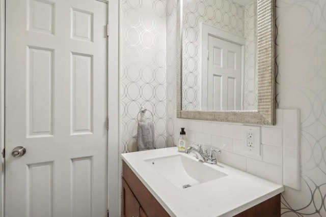 bathroom with vanity and decorative backsplash