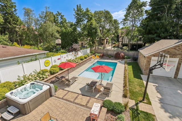 view of pool with a hot tub, an outdoor structure, a fenced backyard, and a patio