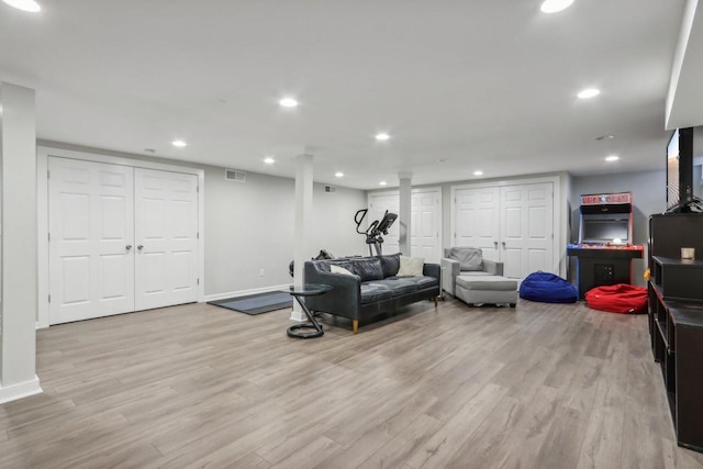 workout area featuring light wood-type flooring, visible vents, and recessed lighting