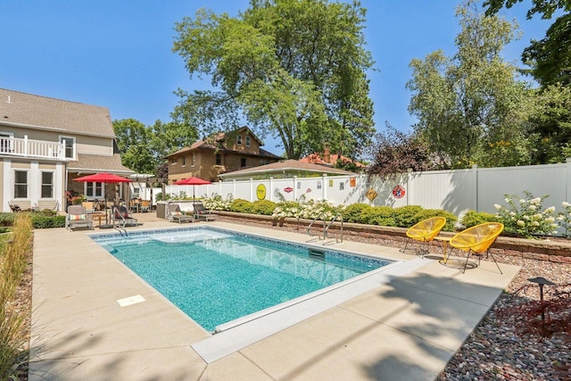 view of pool featuring a patio area, a fenced backyard, and a fenced in pool