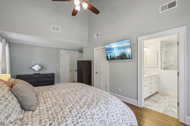 bedroom featuring baseboards, visible vents, and light wood-style flooring