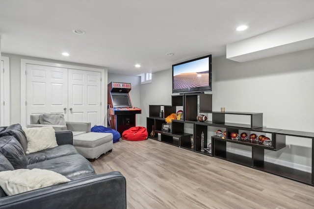 living area with recessed lighting and light wood-style floors