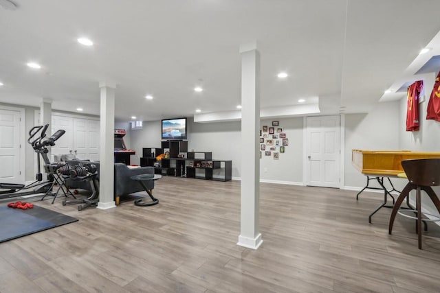 workout area featuring light wood finished floors, baseboards, and recessed lighting