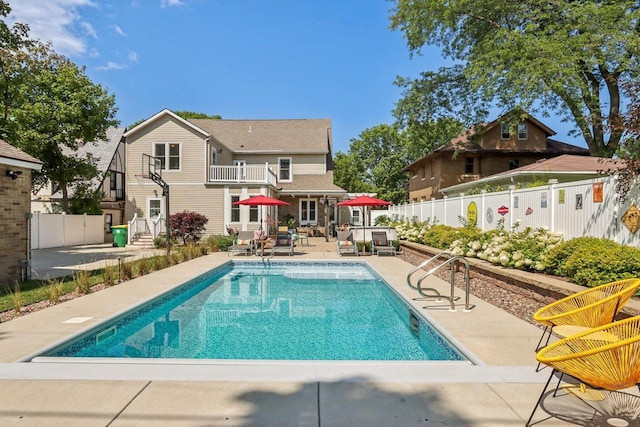 view of swimming pool with a fenced in pool, a fenced backyard, and a patio