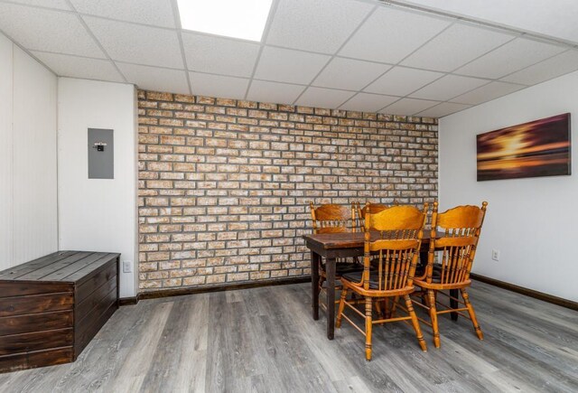 297 Debuhr Ln, Platteville, WI 53818 - dining space with wood finished floors, a paneled ceiling, and baseboards