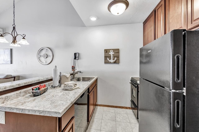 kitchen with decorative light fixtures, brown cabinetry, light tile patterned flooring, a sink, and black appliances