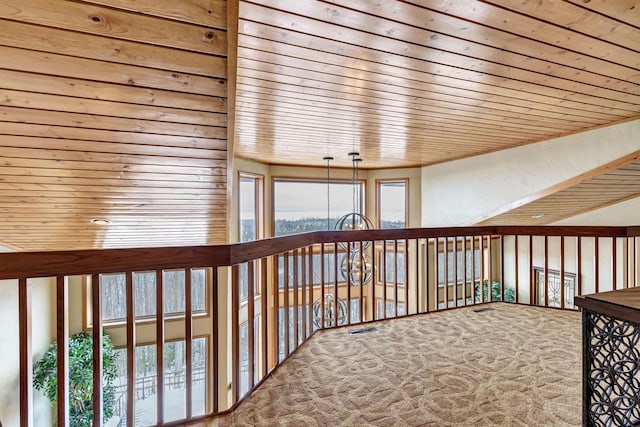 hallway featuring wooden ceiling, carpet flooring, and visible vents