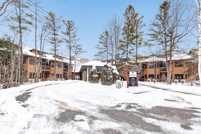 snowy yard featuring a garage