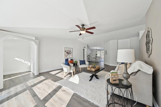 living room featuring lofted ceiling, ceiling fan, wood finished floors, and baseboards