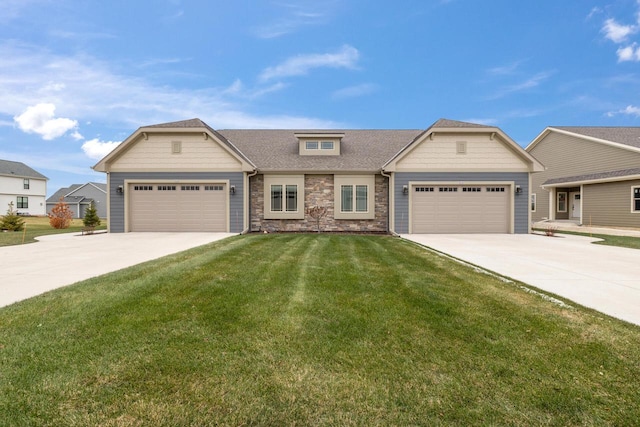 view of front of property featuring an attached garage, stone siding, a front yard, and driveway