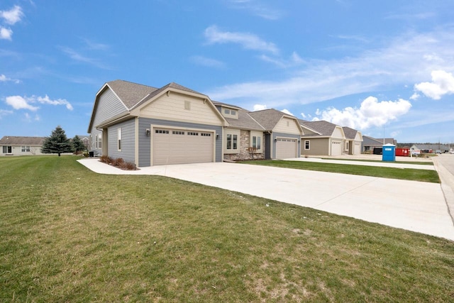 view of front facade featuring concrete driveway, an attached garage, a residential view, stone siding, and a front lawn