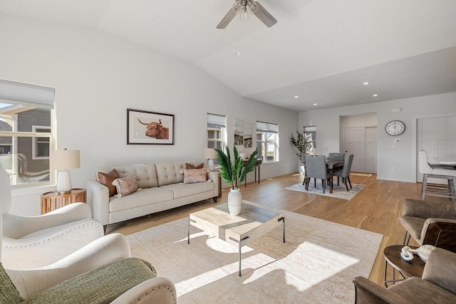 living room featuring light wood-style floors, recessed lighting, vaulted ceiling, and a ceiling fan