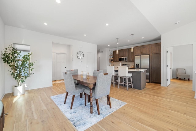 dining room with light wood-type flooring and recessed lighting