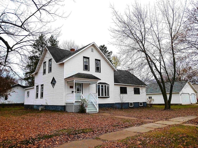 view of front facade featuring a shingled roof and a chimney